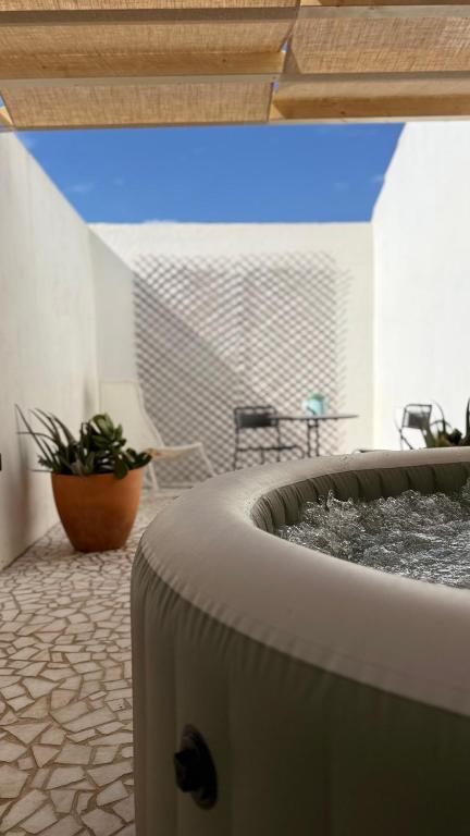 a room with a fountain in the middle of a building at Habita SerpaPinto in Estremoz