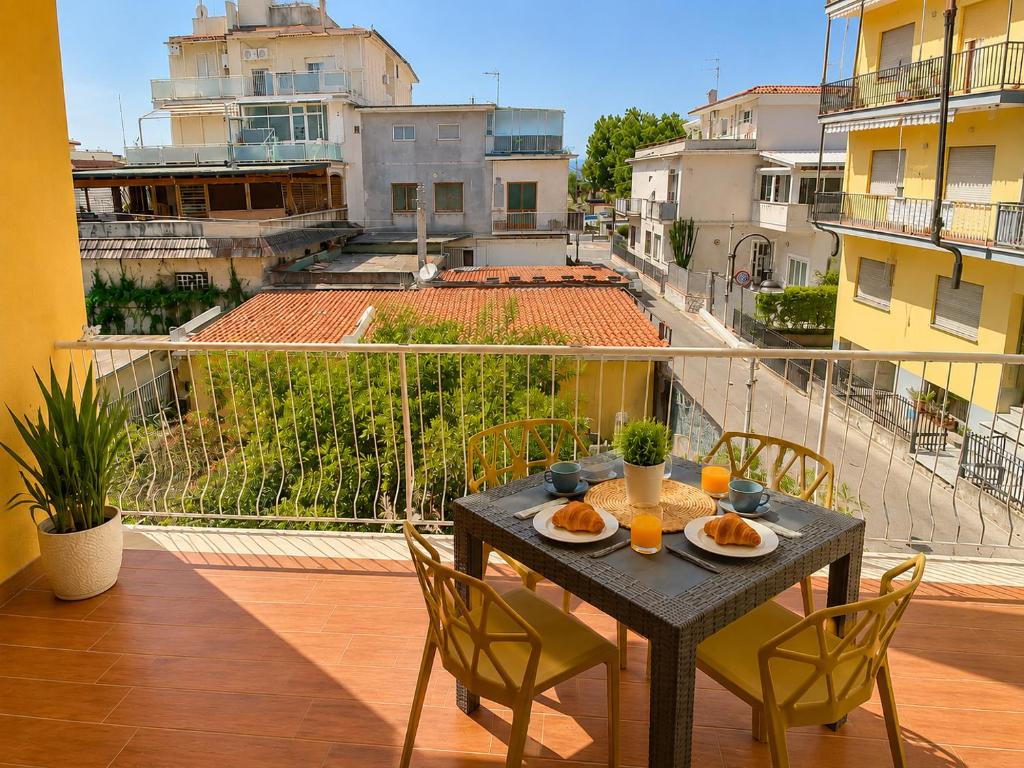 a table with plates of food on top of a balcony at Casa Annalisa in Scauri