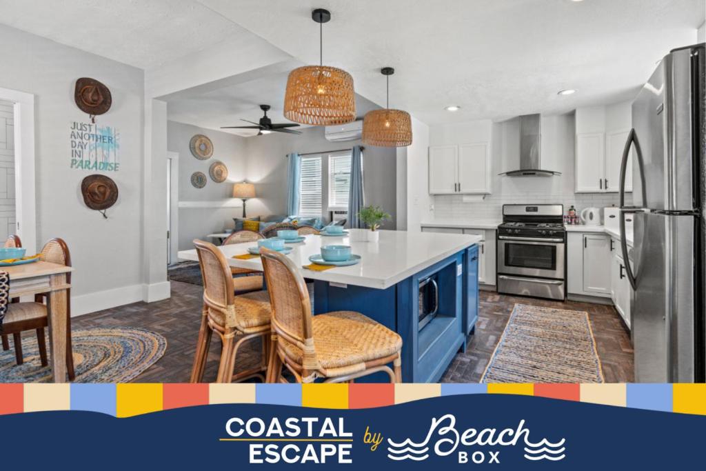 a kitchen with a blue island in a room at Coastal Escape, Steps to Beach, Fire Pit in Galveston