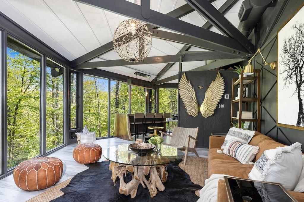 a living room with a couch and a table at Breathtaking Boutique Treehouse nestled in clouds in Beech Mountain