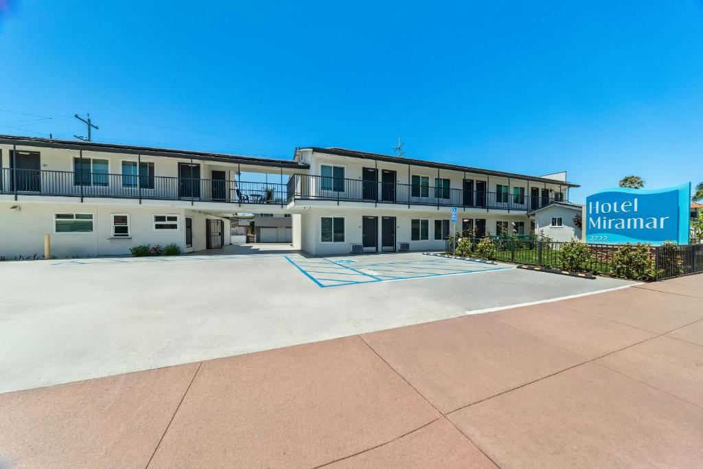 a large white building with a sign in front of it at Hotel Miramar in San Clemente