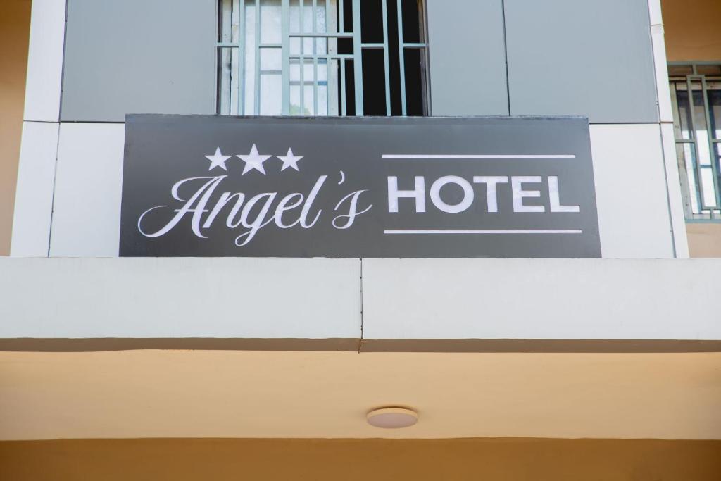 a sign for an angel hotel on top of a building at Angel's hôtel in Douala