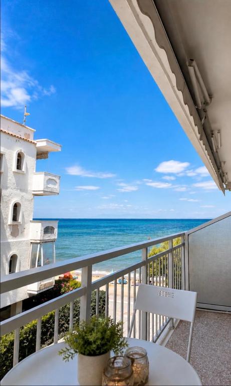 a balcony with a table and a view of the ocean at Irene Beach Front Luxury Suite in Perea