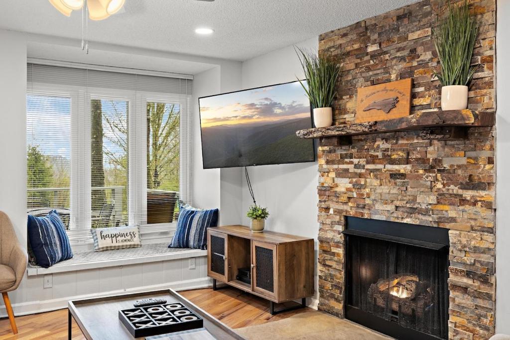 a living room with a fireplace and a tv at Hiking Trails King Bed View Recently Renovated in Sugar Mountain