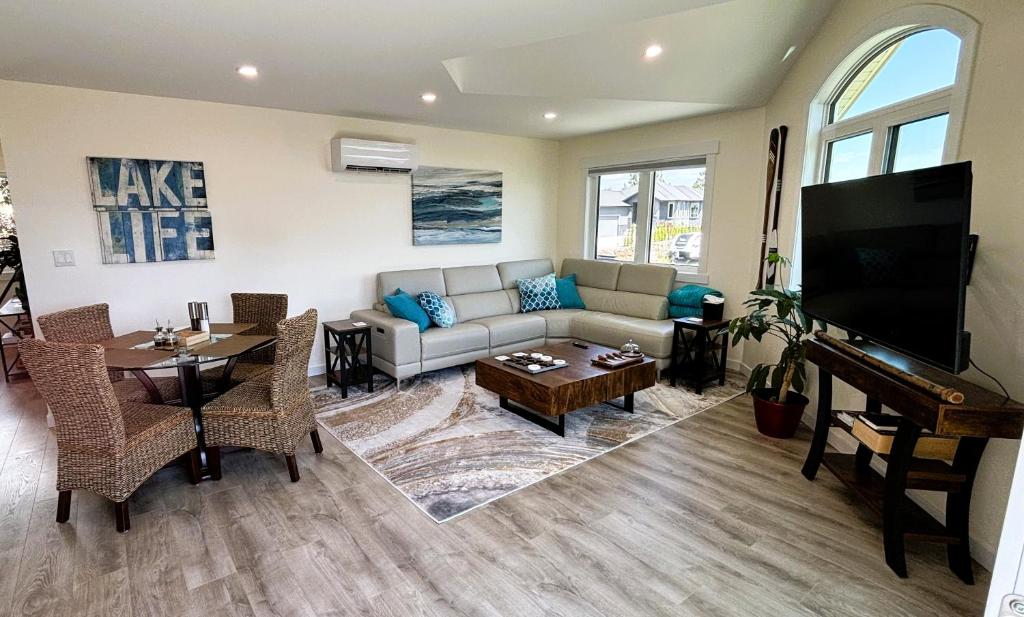 a living room with a couch and a piano at Lake View Escape! in West Kelowna
