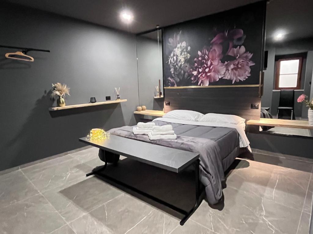 a bedroom with a bed with a table in it at Davis Kaizen in Brindisi