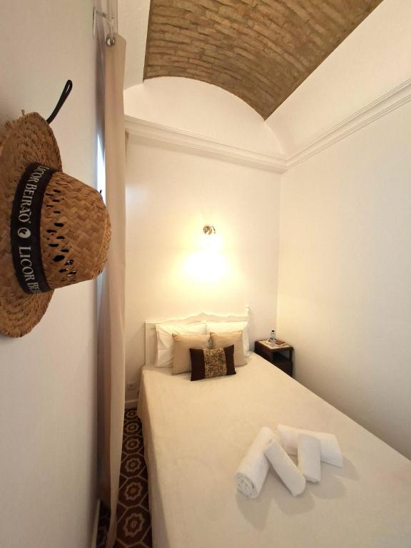 a bedroom with a bed with two towels on it at Olhão Barreta typical home ASM in Olhão