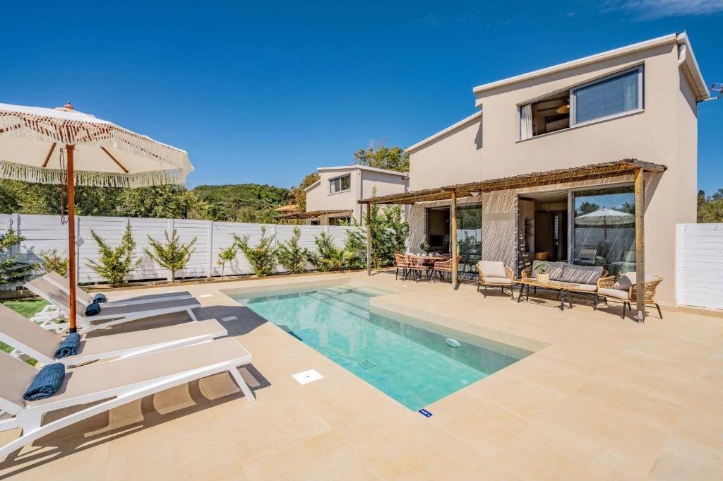 a villa with a swimming pool and a house at Villa Romas 2 by Villa Plus in Vasilikos