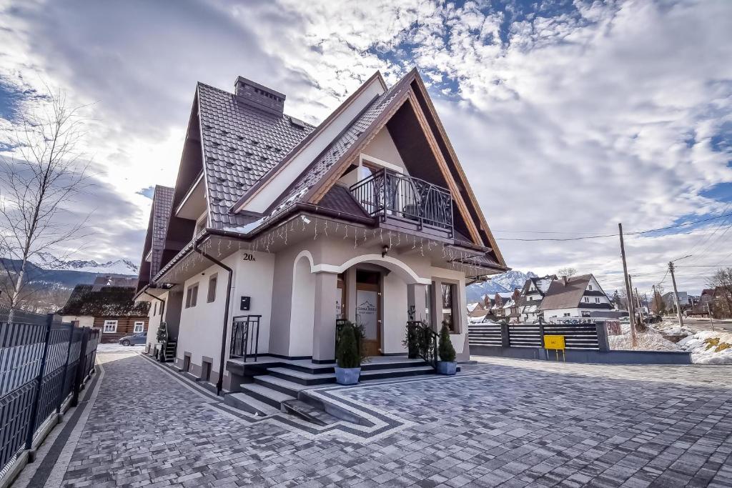 a small white house with a gambrel roof at Czarna Turnia -ZAKOPANE in Zakopane