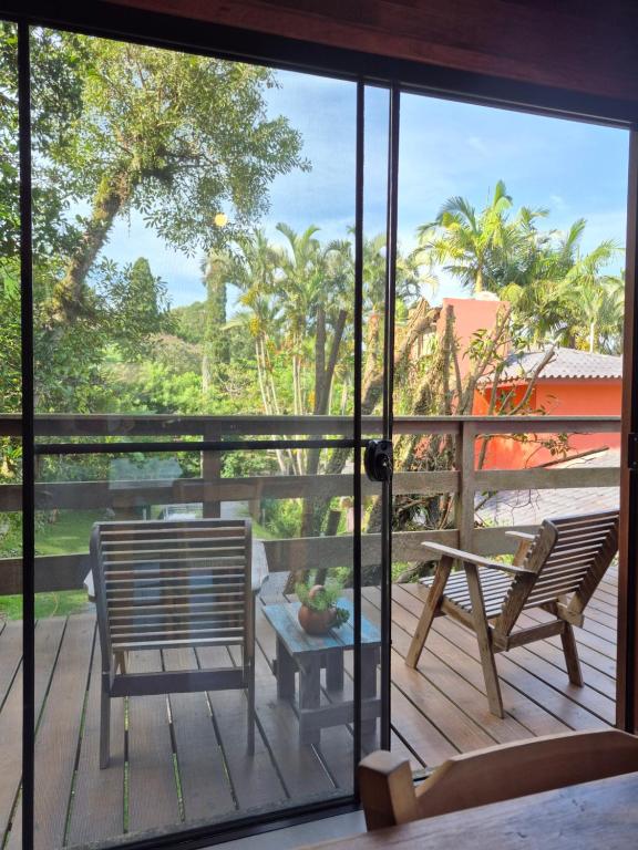 a view from the balcony of a villa with a table and chairs at Charme e conforto - surf pertinho de casa in Garopaba