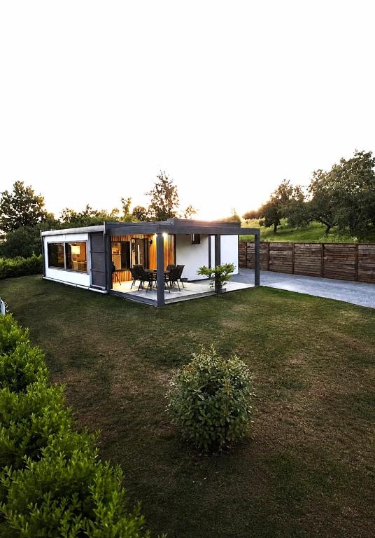 a small house in the middle of a yard at Panorama House in Bartolovci