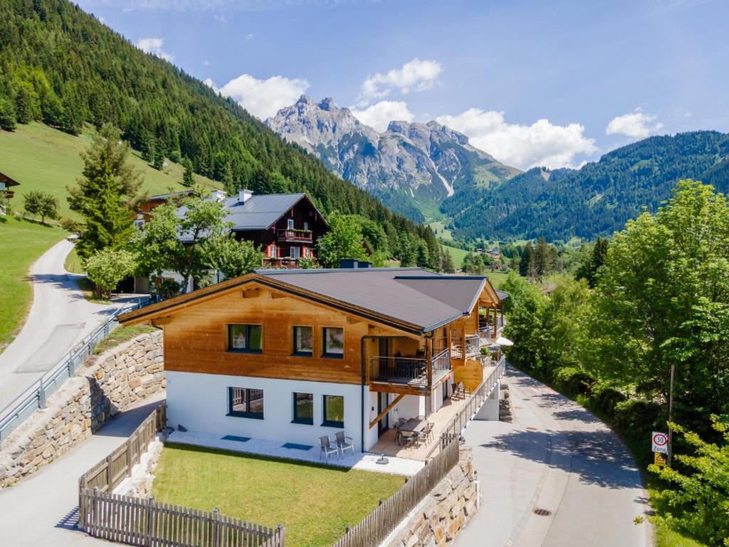 an aerial view of a house with mountains in the background at Bergblick in Werfenweng