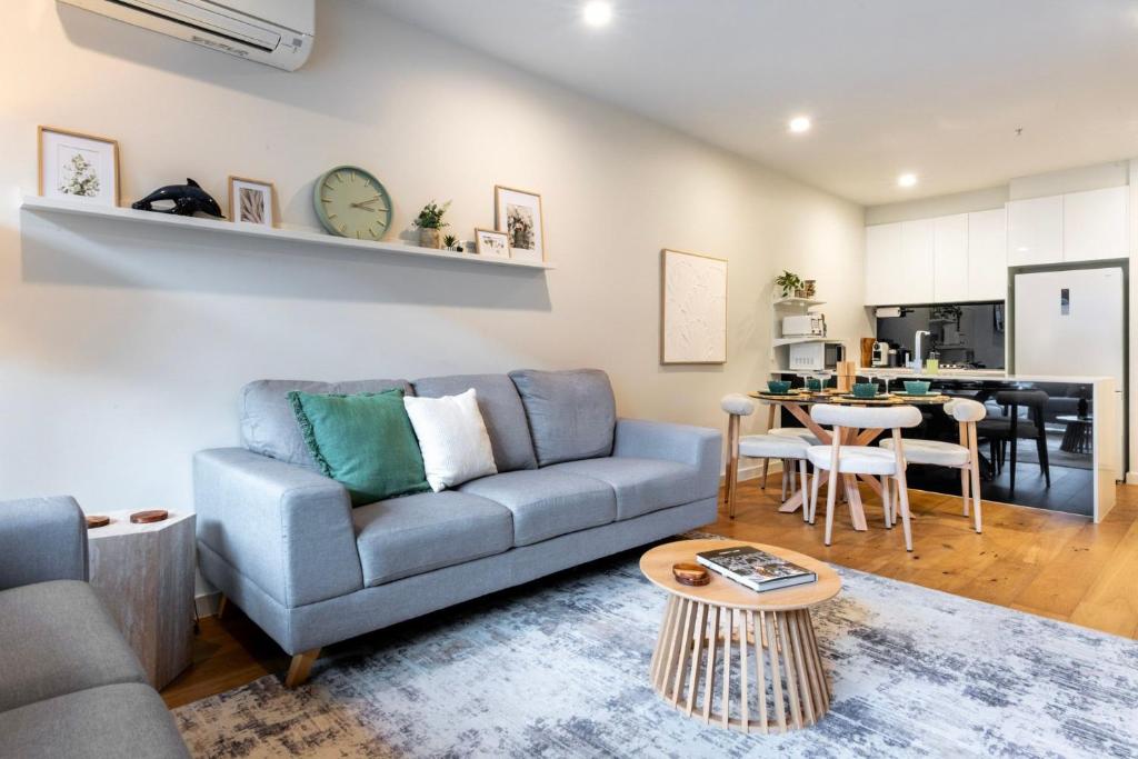 a living room with a couch and a table at Bentleigh & Beyond Your Melbourne Getaway in Melbourne