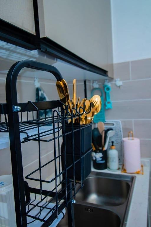 a basket of kitchen utensils sitting next to a sink at Beryl's Haven in Marimbeti