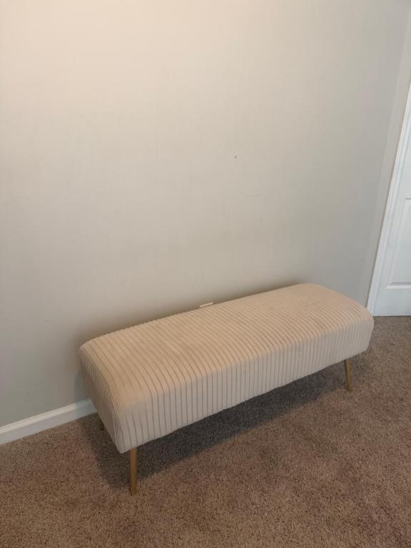 a bench sitting in a corner of a room at Stone Homes in Lawrenceville