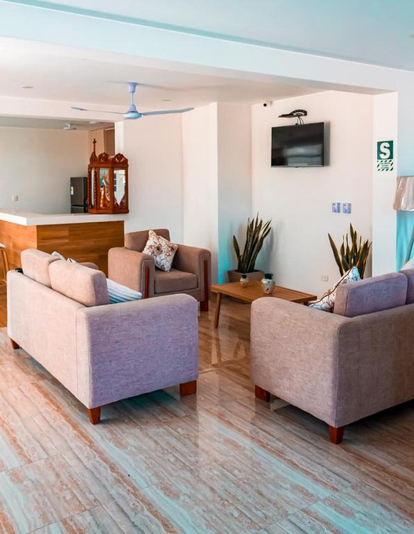a living room with two couches and a table at Hotel San Cosme in Camaná
