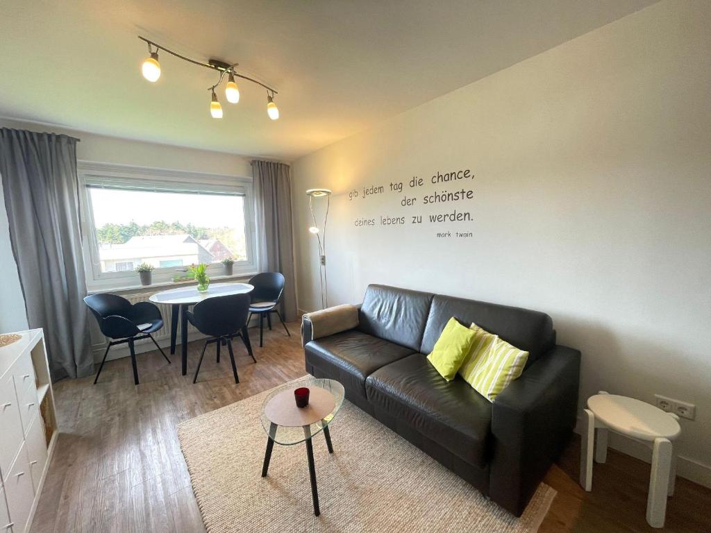 a living room with a couch and a table at Appartement-155 in Westerland