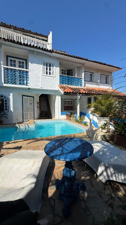 a house with a swimming pool in front of a house at Luah Buziana in Búzios