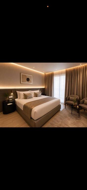 a bedroom with a large bed and a window at tyty cairo hotel in Cairo