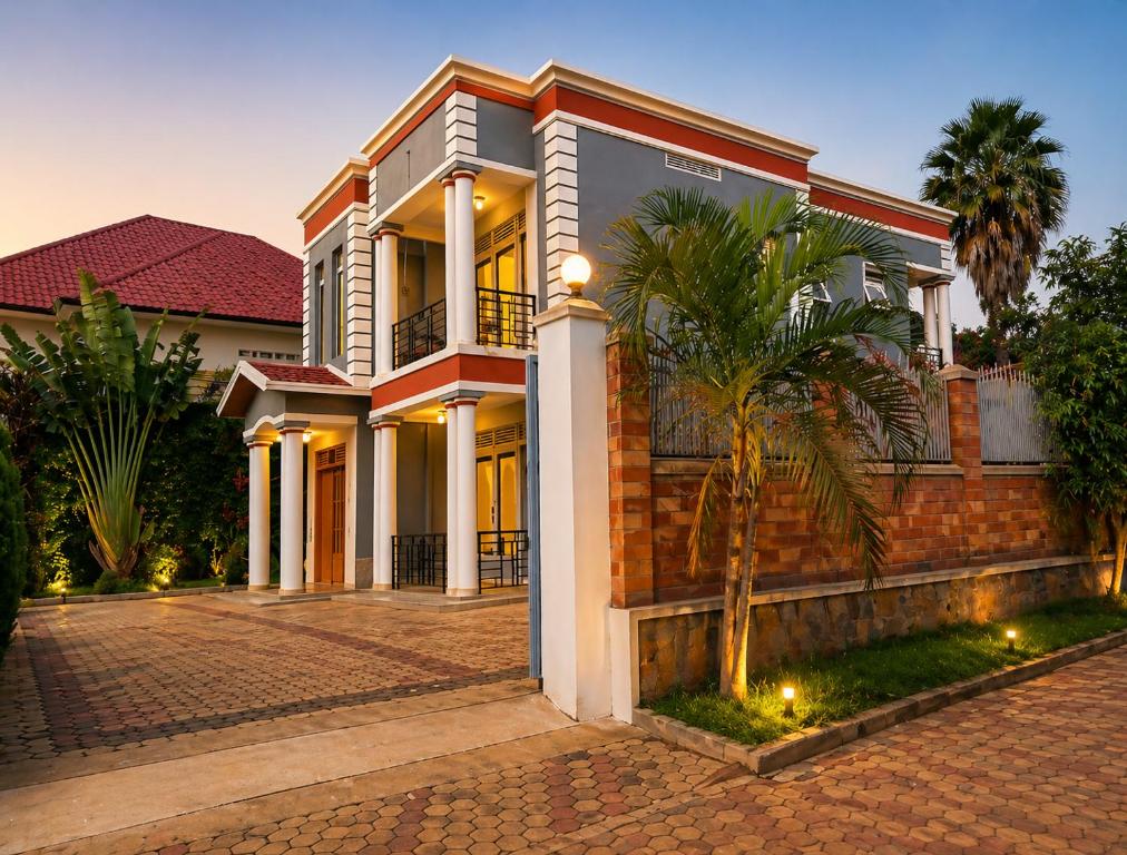 a house with a palm tree in front of it at Maison De Omashi in Kigali