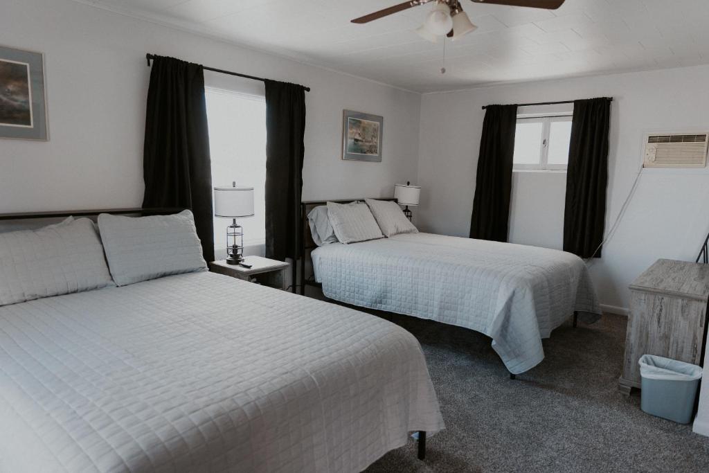a bedroom with two beds and a ceiling fan at The Last Resort in Sault Ste. Marie