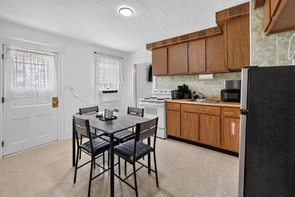 a kitchen with a black table and chairs in it at Charming 2-Bedroom, 1-Bath Getaway in Carbondale