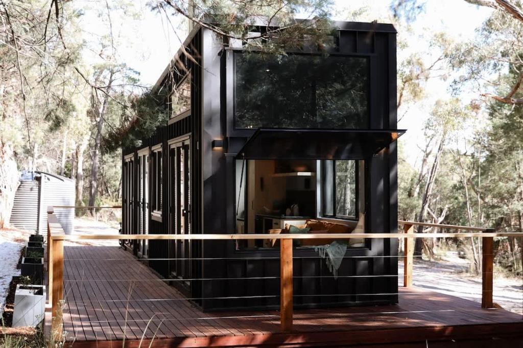a black tiny house on a wooden deck at SHAK Halls Gap - Off Grid Tiny Home in Halls Gap