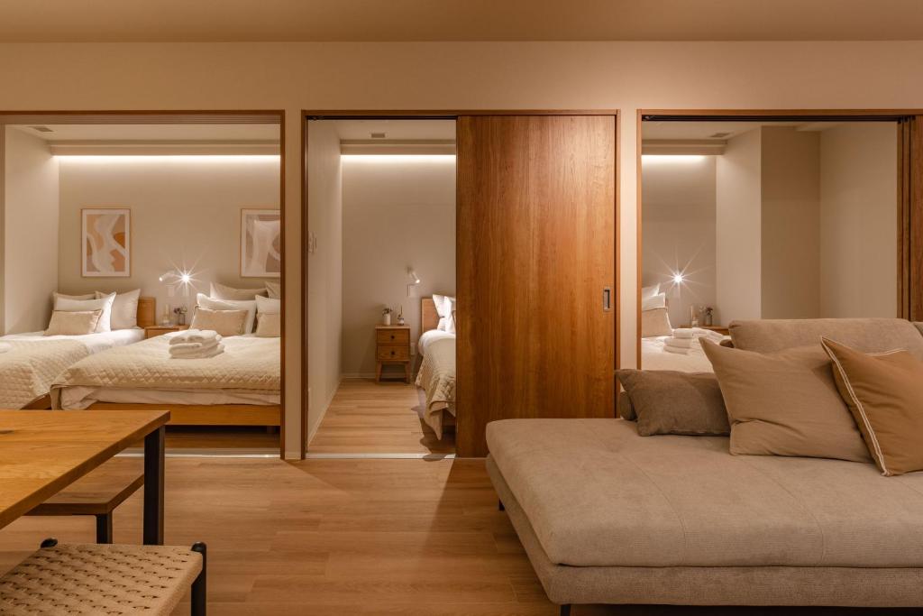 a living room with two beds and a couch at SoMA Kagurazaka in Tokyo