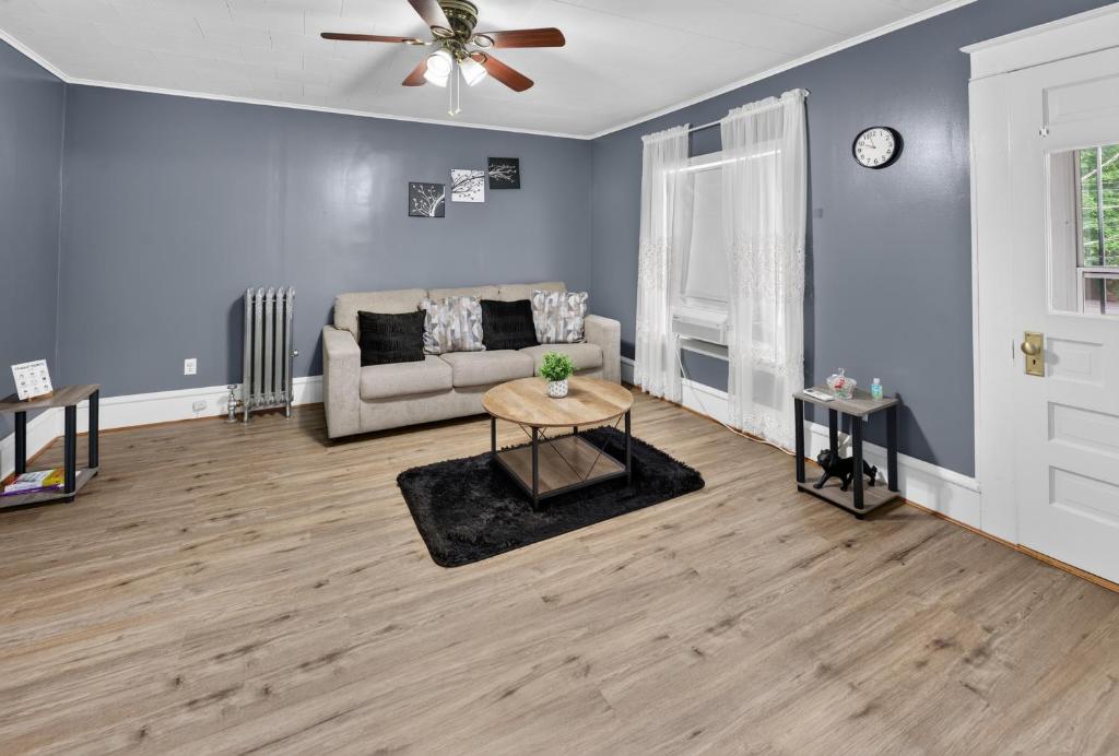 a living room with a couch and a ceiling fan at 1-Bedroom, 1-Bath Getaway in Carbondale
