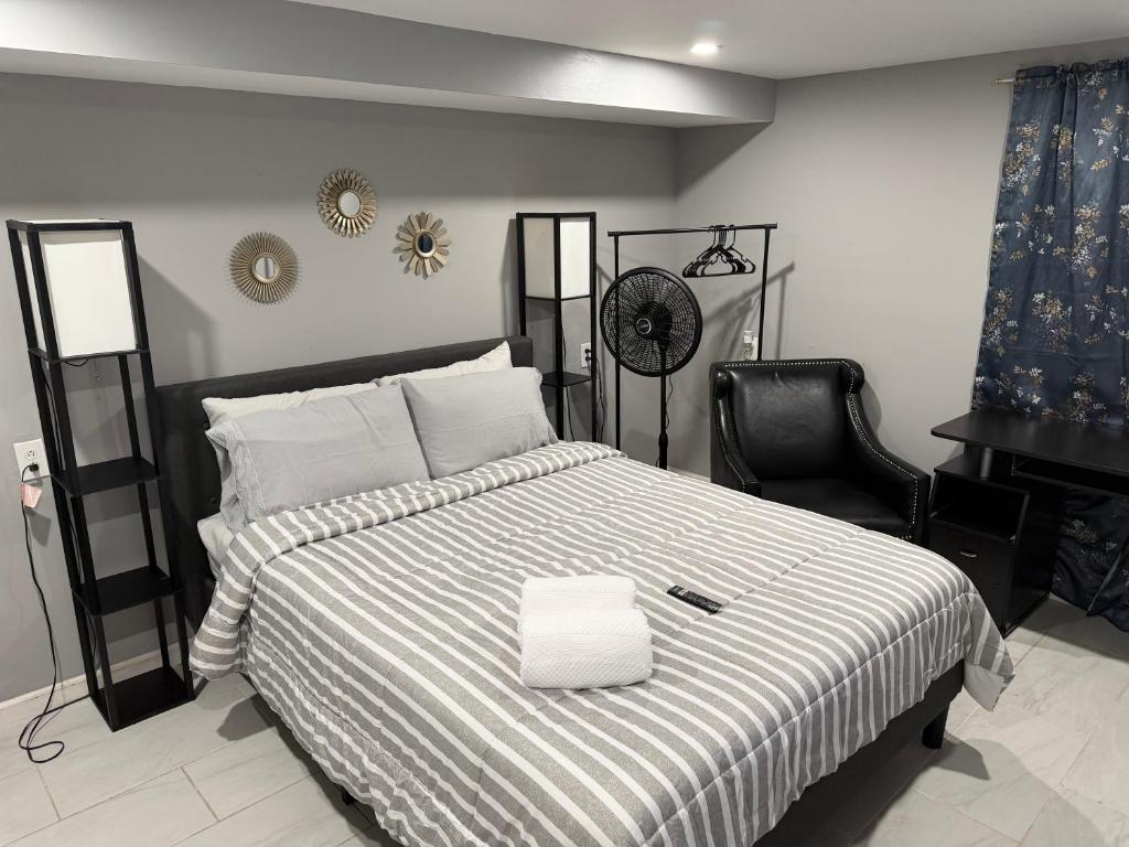 a bedroom with a bed with a black and white blanket at 50 Private Lounge in Irvington