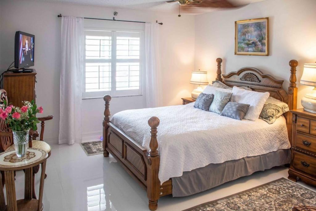 a bedroom with a large bed and a window at Jupiter Bay Beach Condo in Jupiter