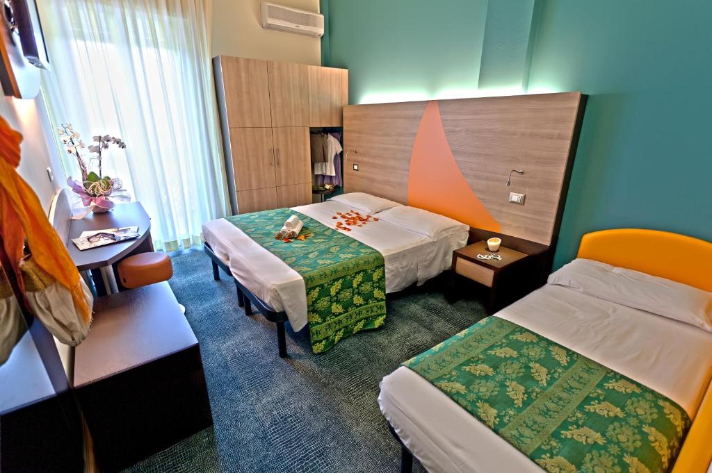 Postel nebo postele na pokoji v ubytování Hotel Sorriso