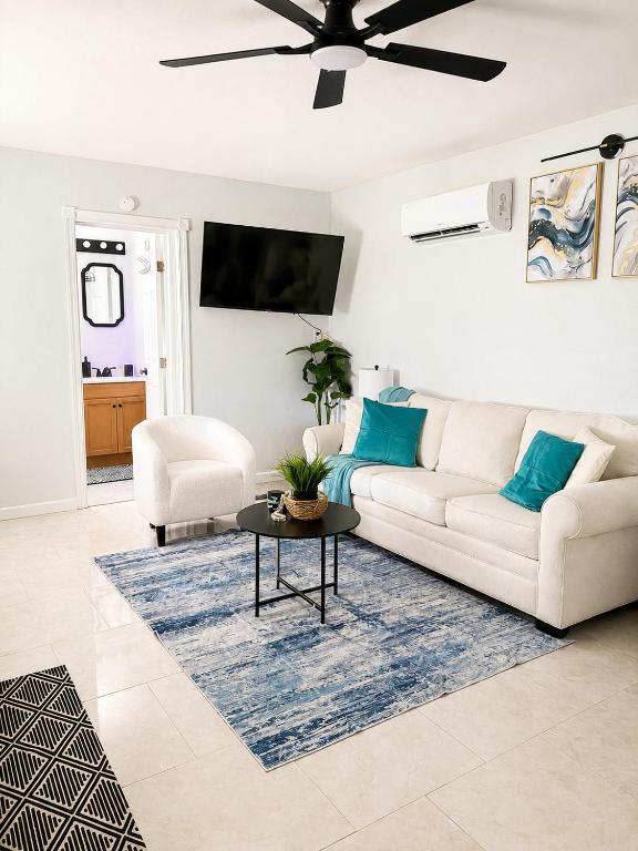 a living room with a white couch and a table at The Arlington Hideaway in Jacksonville