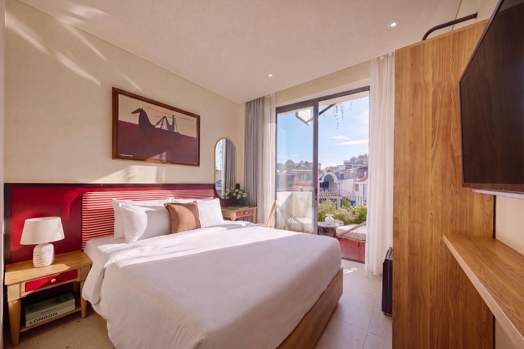 a bedroom with a large bed and a large window at LoverA Signature Hotel in Ho Chi Minh City