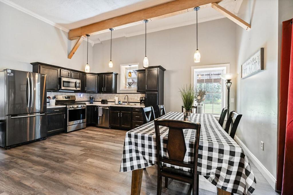 a kitchen with a table with a checkered table cloth at Country Style Home 4br 2bth in Brewer