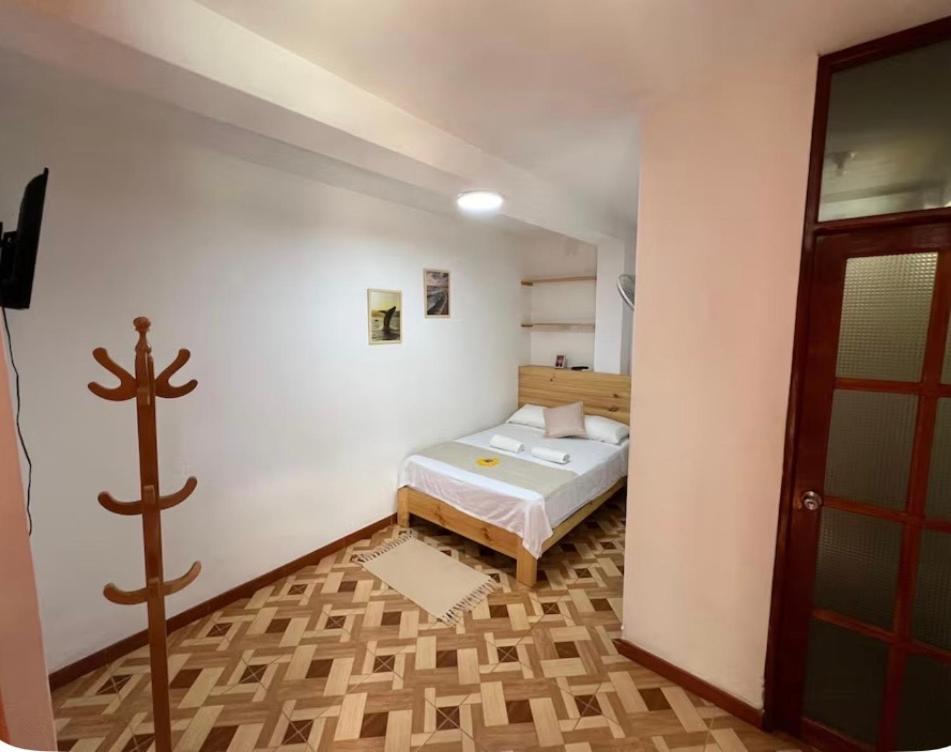 a bedroom with a bed in a white room at Mihahi Beach Mancora in Máncora