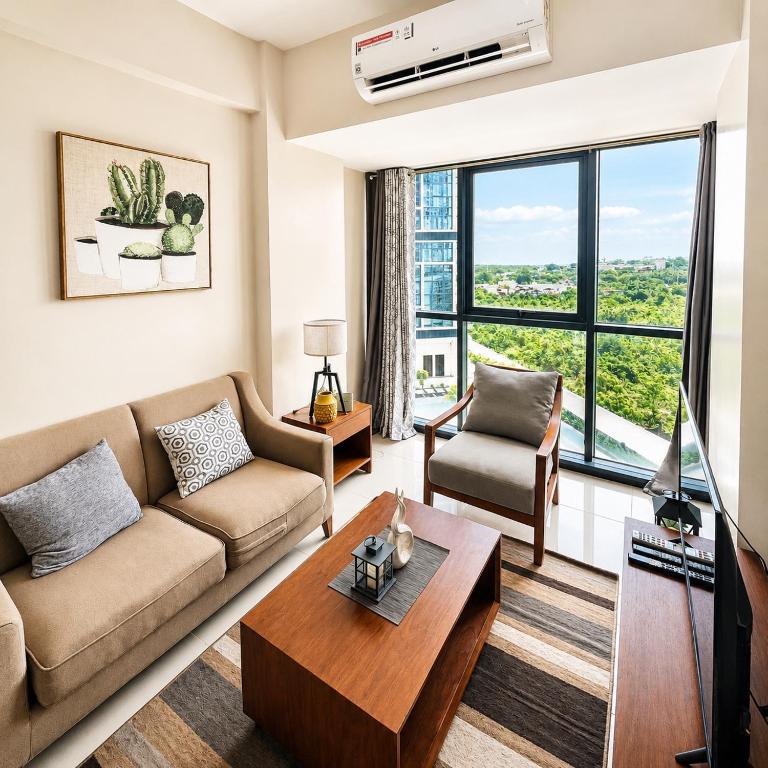a living room with a couch and a table at The Mactan Beach Condo Staycation in Punta Engaño