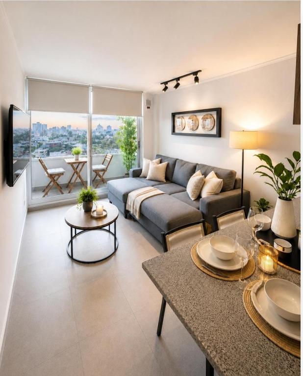 a living room with a couch and a table at Nómade Summer Home in Iquique