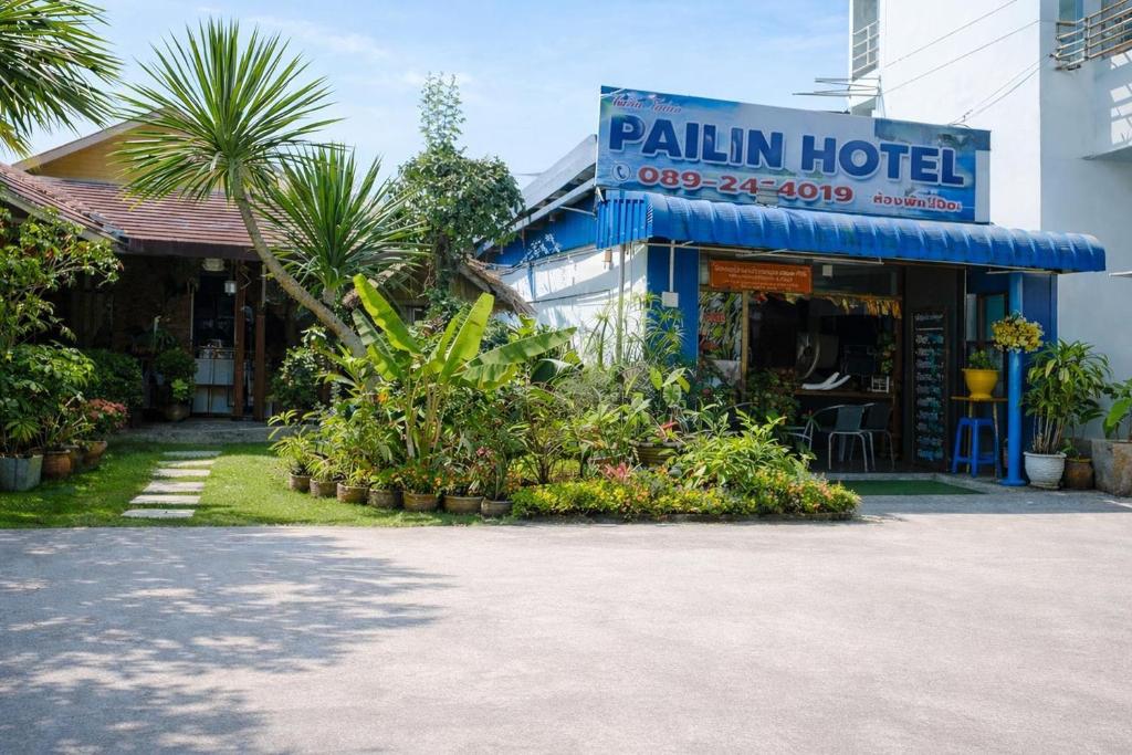 a hotel with plants in front of a building at Pailin Hotel Krabi in Klong Muang Beach