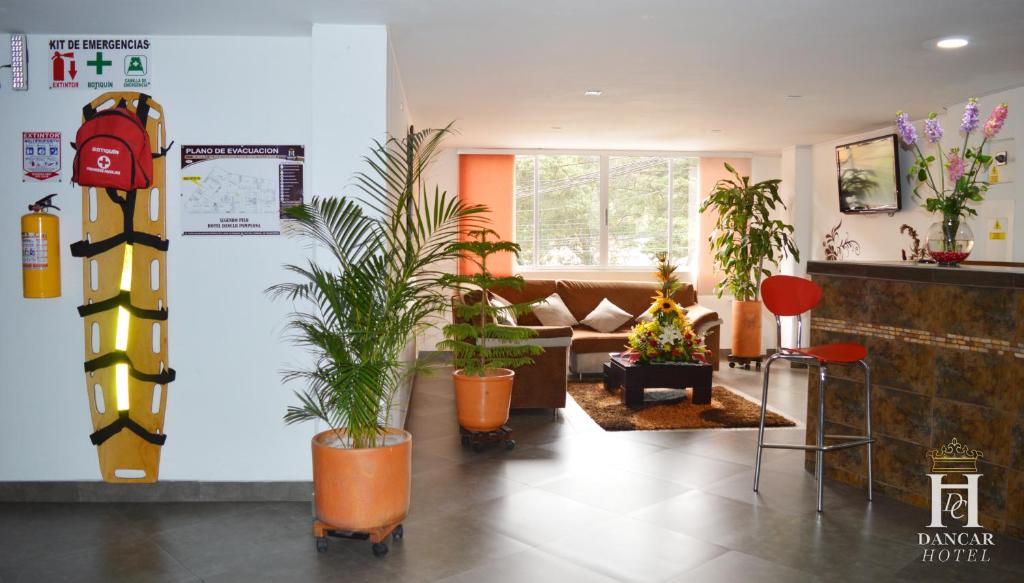 a lobby with potted plants in a room at Hotel Dancar in Pamplona