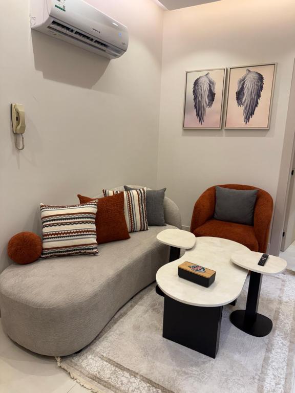a living room with a couch and two tables at الربوه سويت in Jeddah