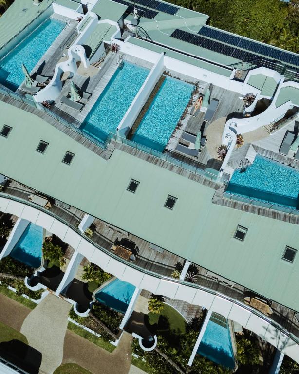 an overhead view of a building with two swimming pools at Beach Suites in Byron Bay