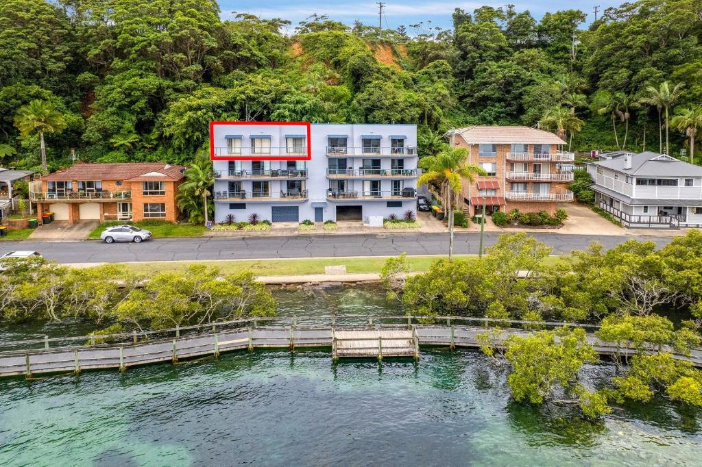 an aerial view of a building next to a body of water at Estuary in Nambucca Heads