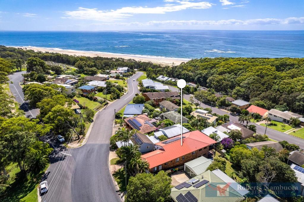 an aerial view of a town with a road and the ocean at 57Charlton in Nambucca Heads