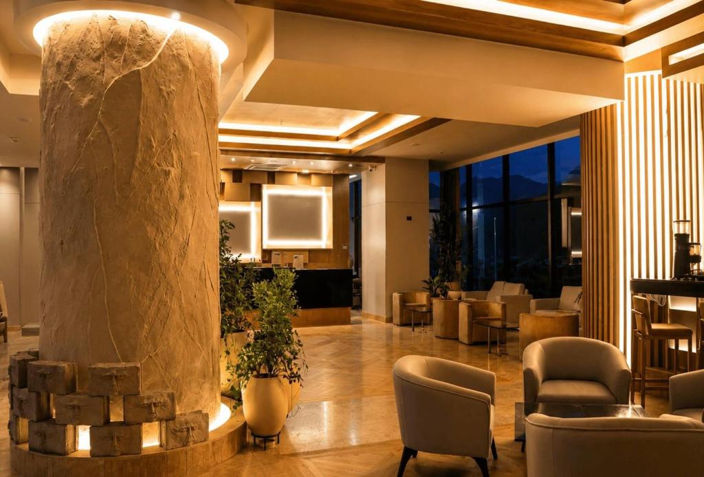 a lobby of a hotel with a pillar and chairs at Wyndham Bogota in Bogotá