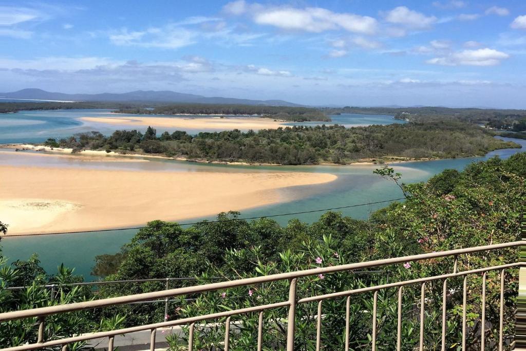 a view of a river with trees and a beach at The Outlook in Nambucca Heads