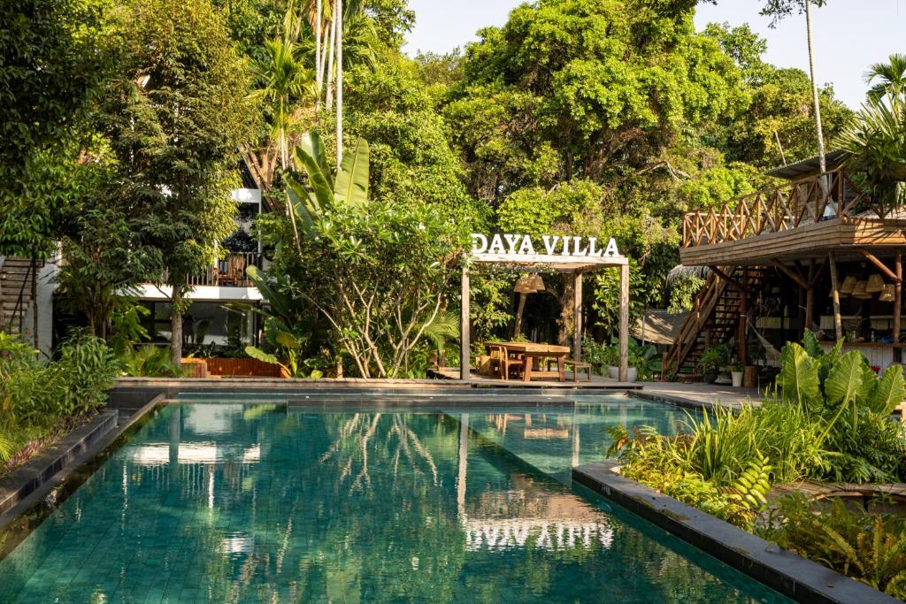 a swimming pool in a resort with a sign that reads pajama at Daya Villa in Kampot