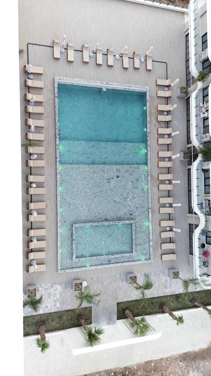 a large swimming pool on the side of a building at Driton`s Apartments in Shëngjin
