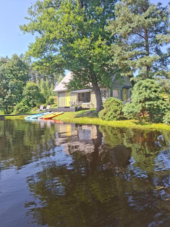 a house on the shore of a river at Kõverajärve saunamaja in Nedsaja