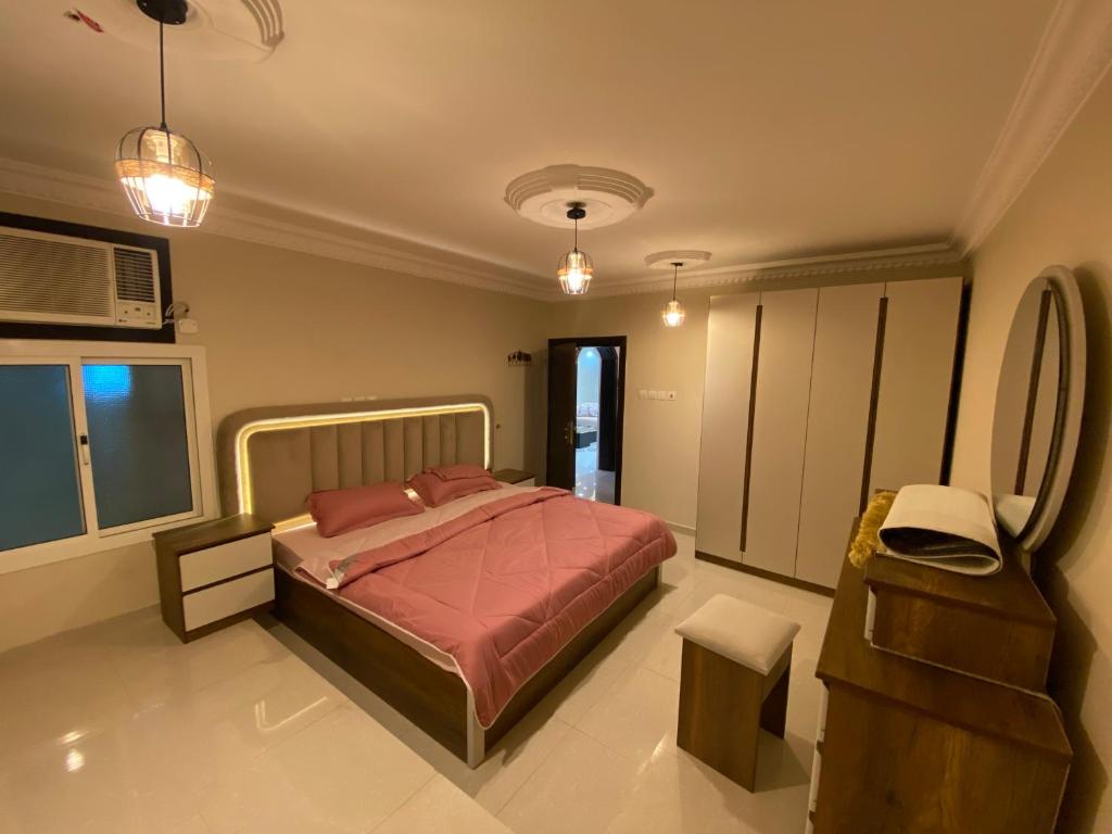 a bedroom with a bed and a chair in it at كازا in Taif